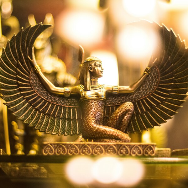 A computer generated image of an Egyptian goddess with golden wings